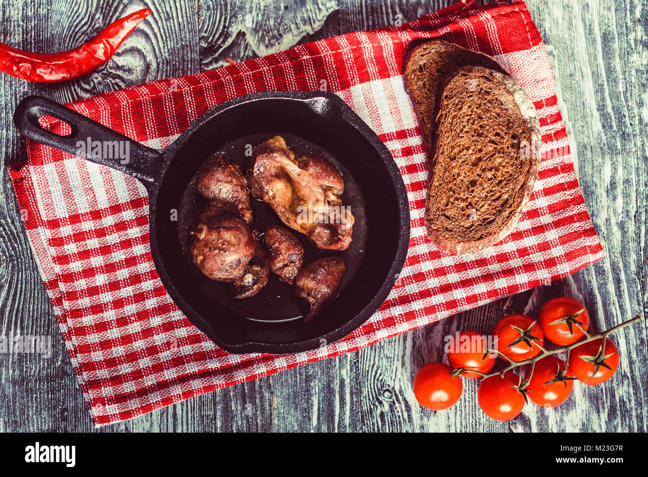 Top view roasted chicken giblets in pan and bread Stock Photo Alamy