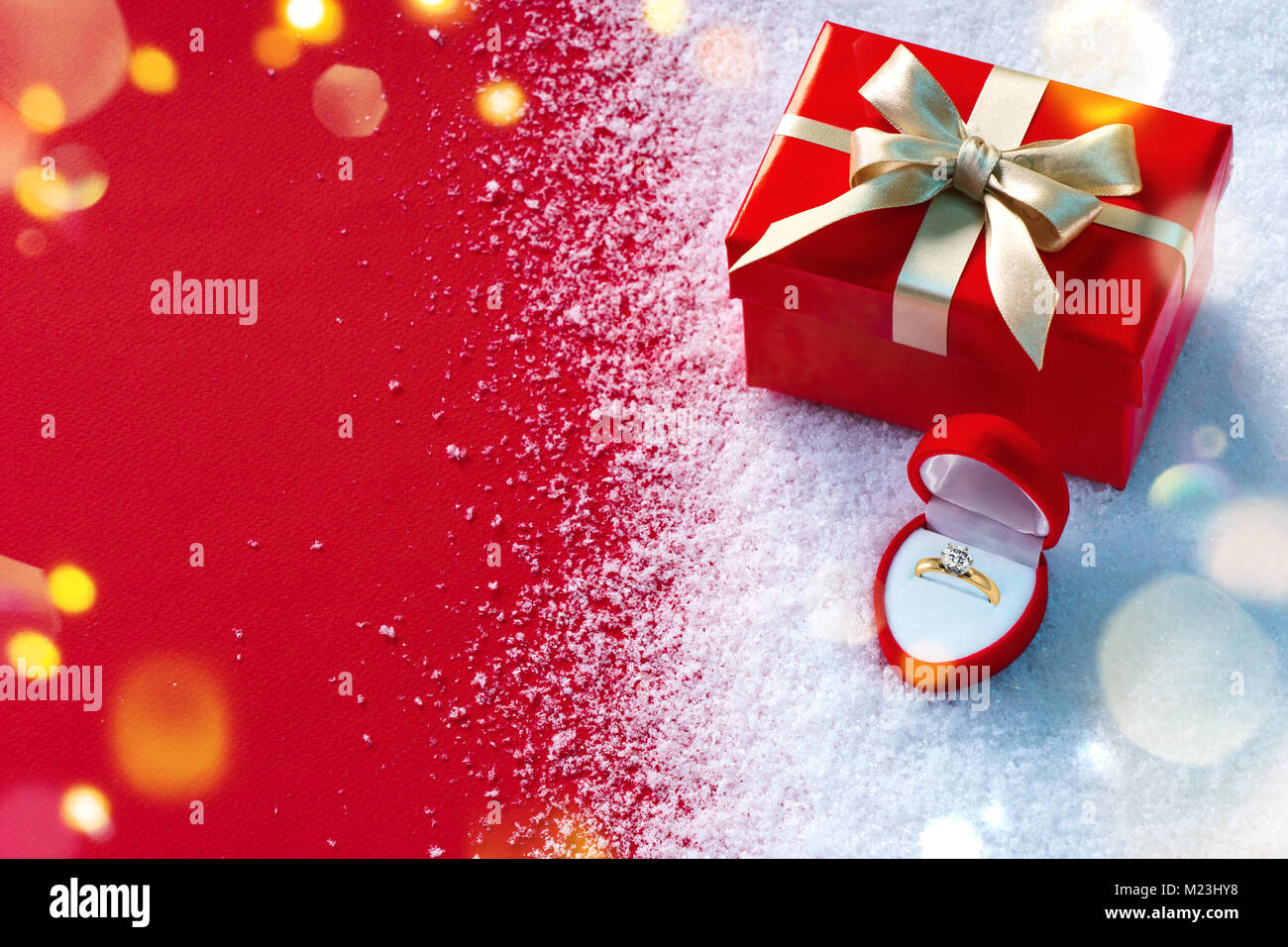 Valentine gift and jewellery box on snow and red background. St. Valentines Day concept Stock Photo