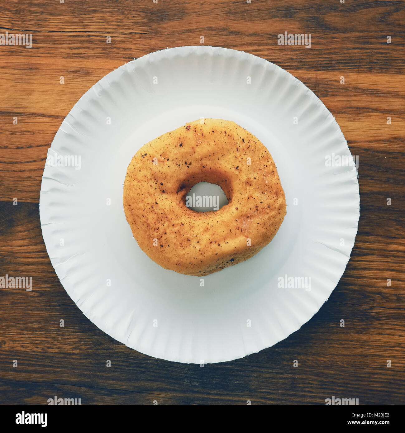 Top view of donut on cardboard plate on wooden table Stock Photo - Alamy
