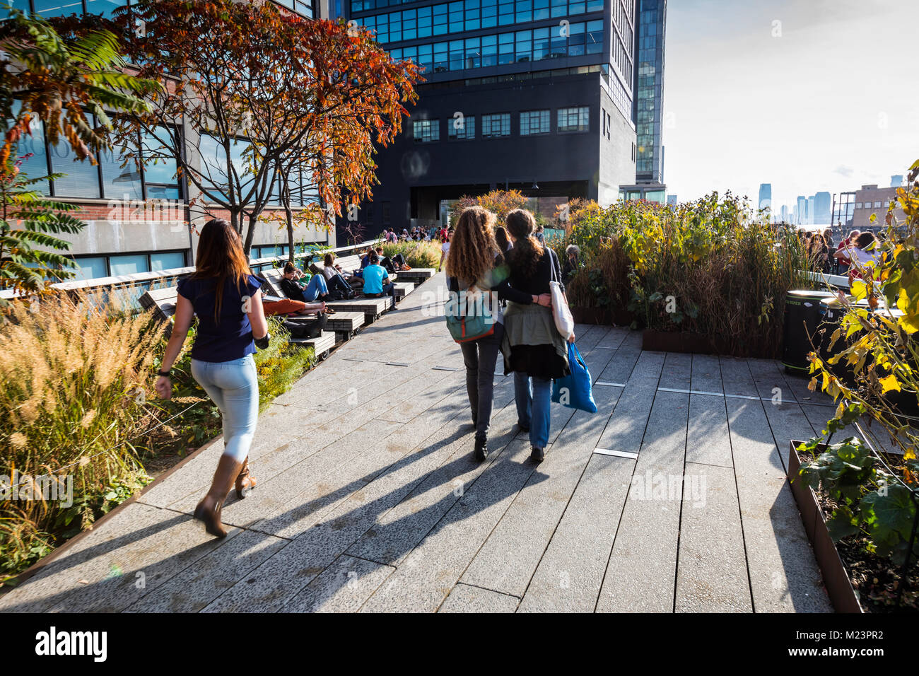 People enjoying free time on High Line park in New York City Stock Photo