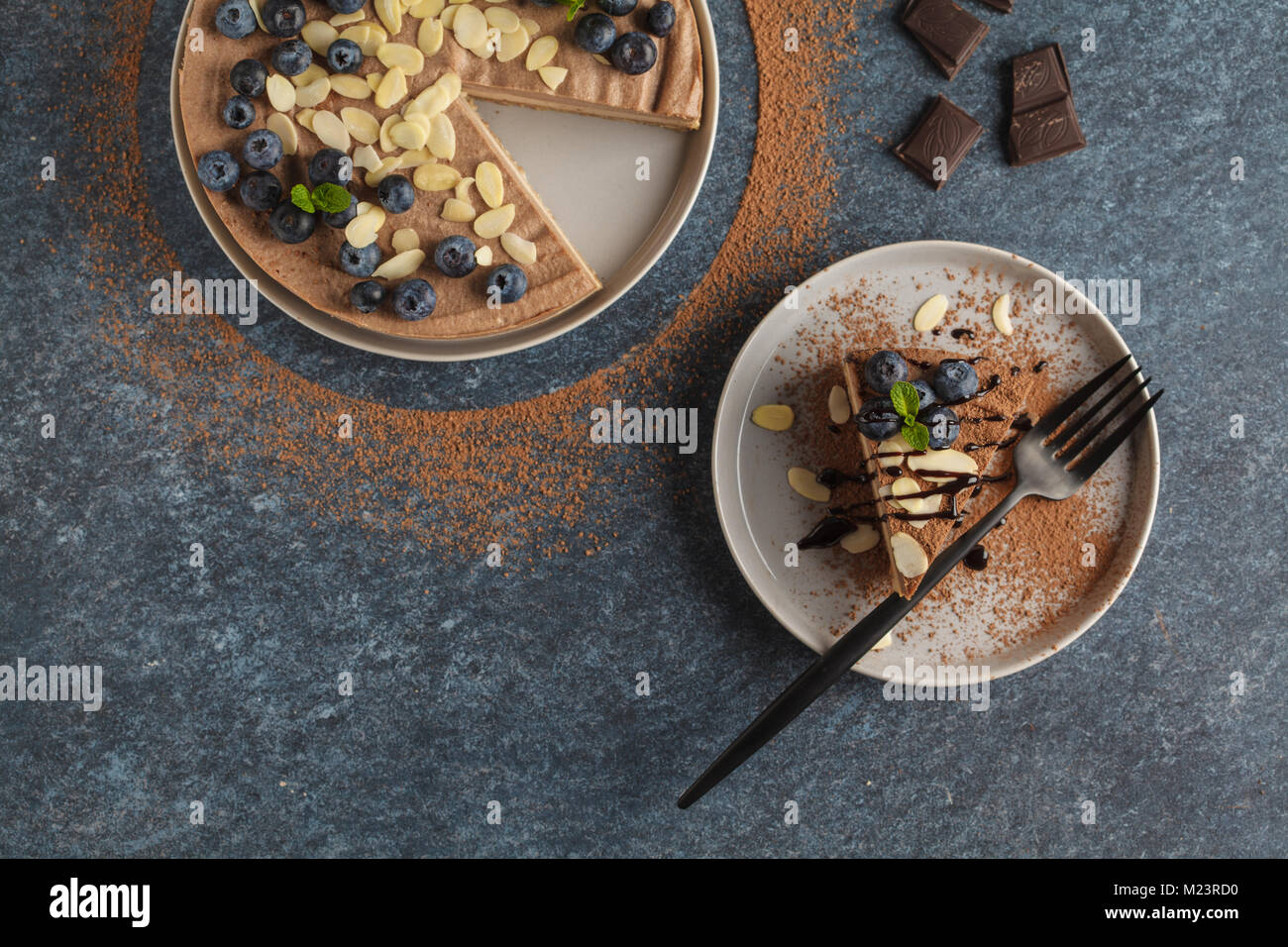 Raw vegan chocolatecaramel cheesecake with blueberries, raw candy