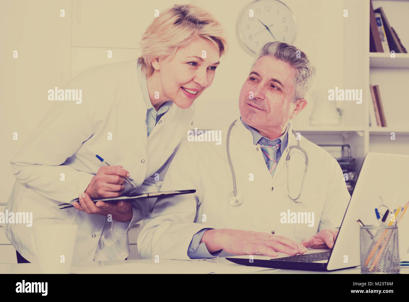 Doctor and nurse check patient data in hospital computer database Stock ...