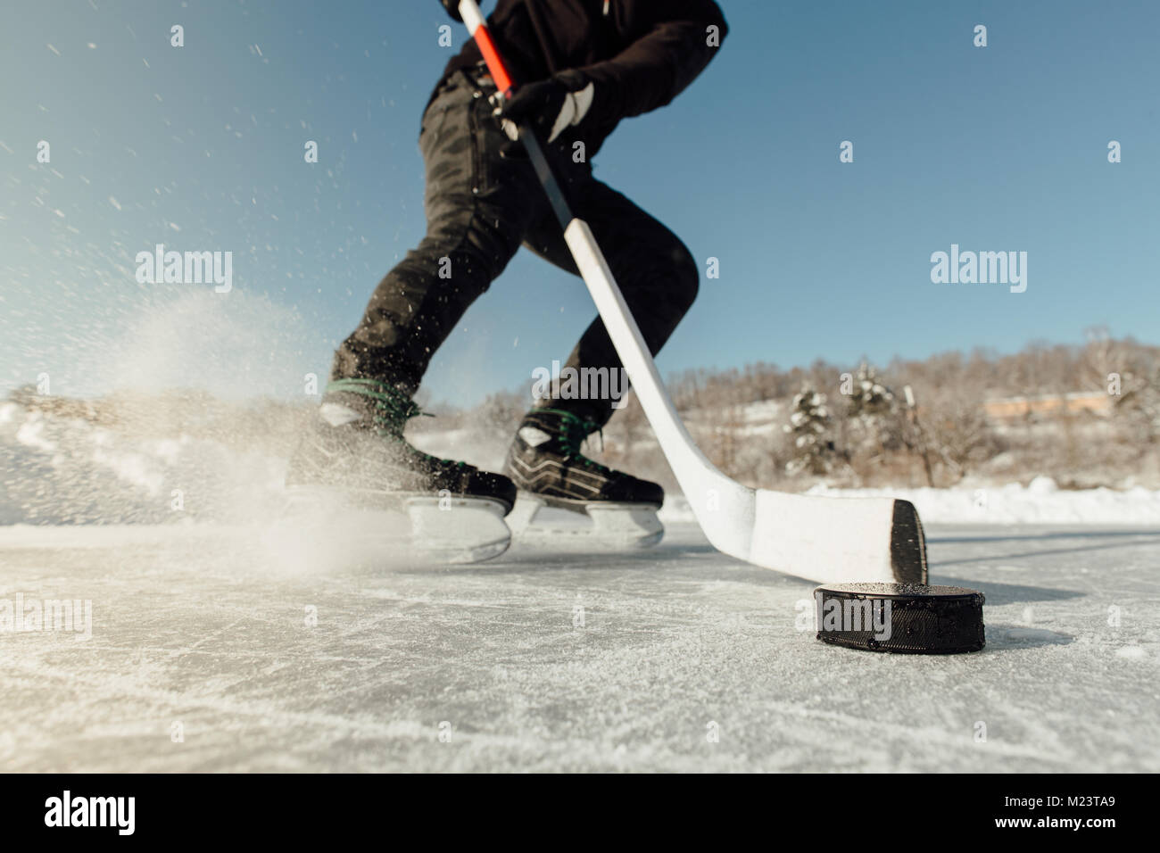 Cropped image of a man puck tracking stopping and spraying ice Stock ...