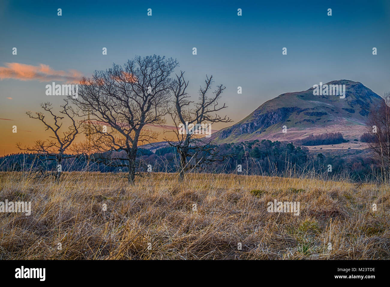 The sun sets near Dumgoyne in the Campsie Fells, near Strathblane, on the West Highland Way, Scotland. Stock Photo