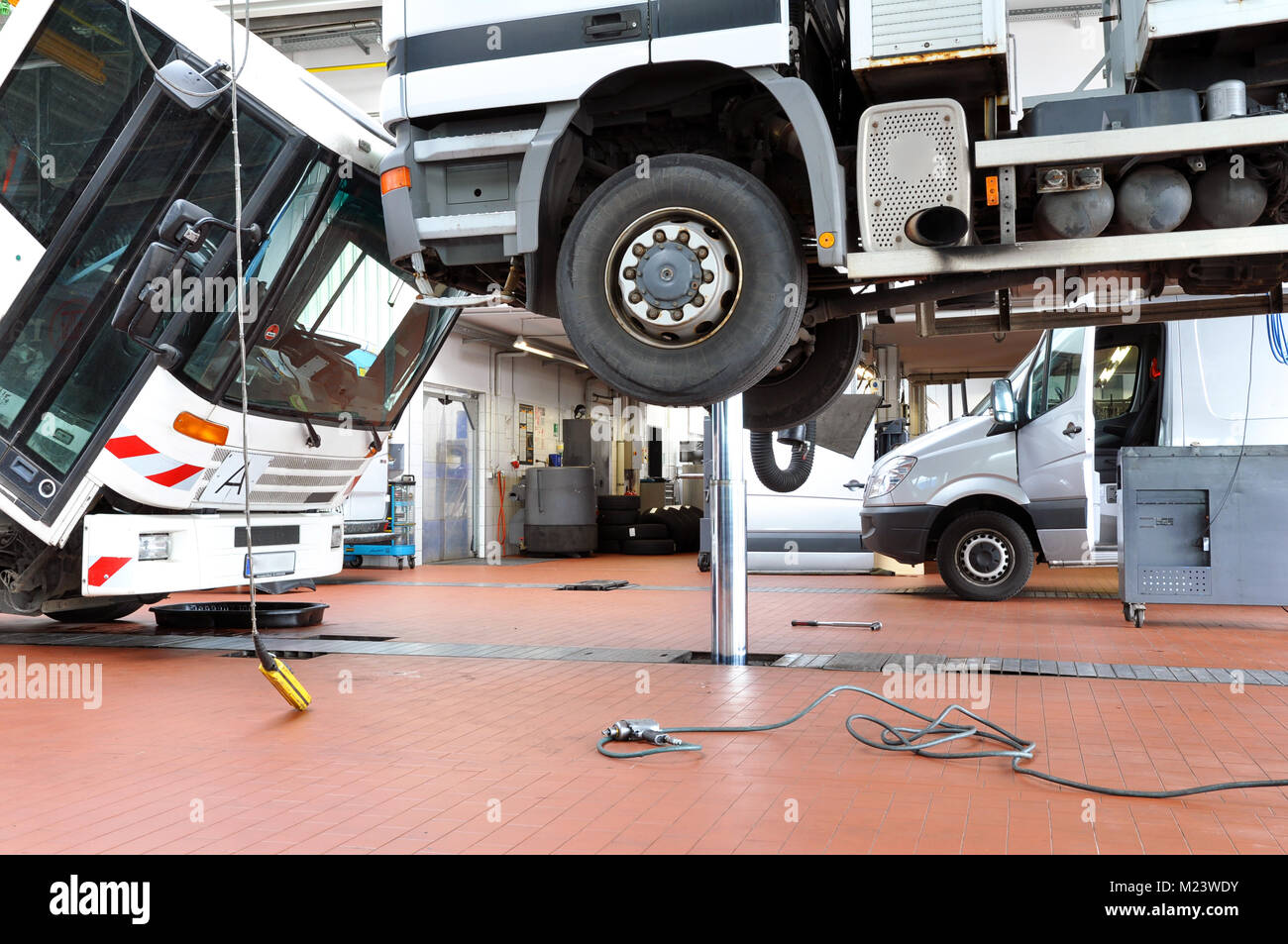 vehicles in a garage - repair and inspection of cars on a lifting platform Stock Photo