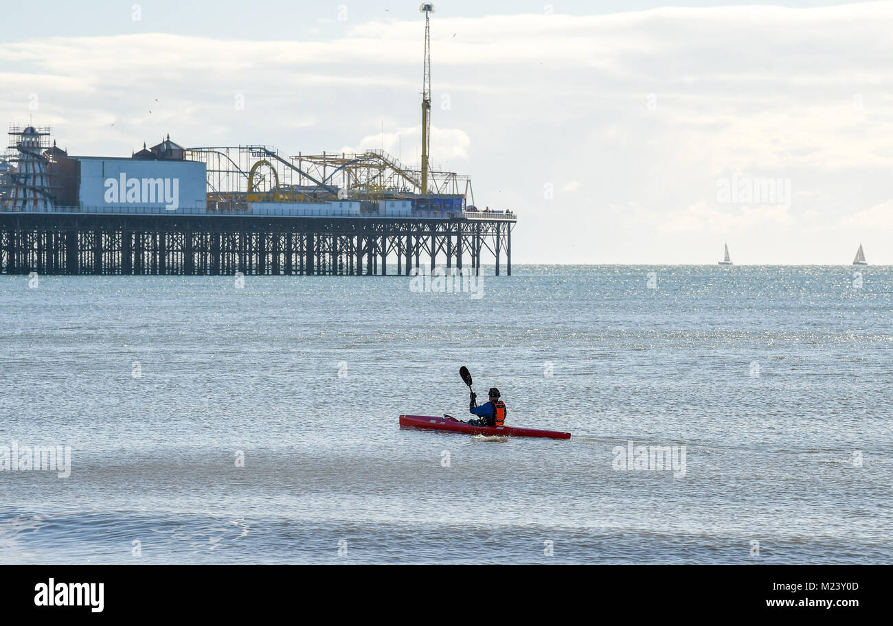 Brighton UK 4th February 2018 - A beautiful sunny day for a paddle by the Palace Pier in Brighton today with the weather forecast to remain cold over the next few days throughout Britain Photograph taken by Simon Dack Credit: Simon Dack/Alamy Live News Stock Photo