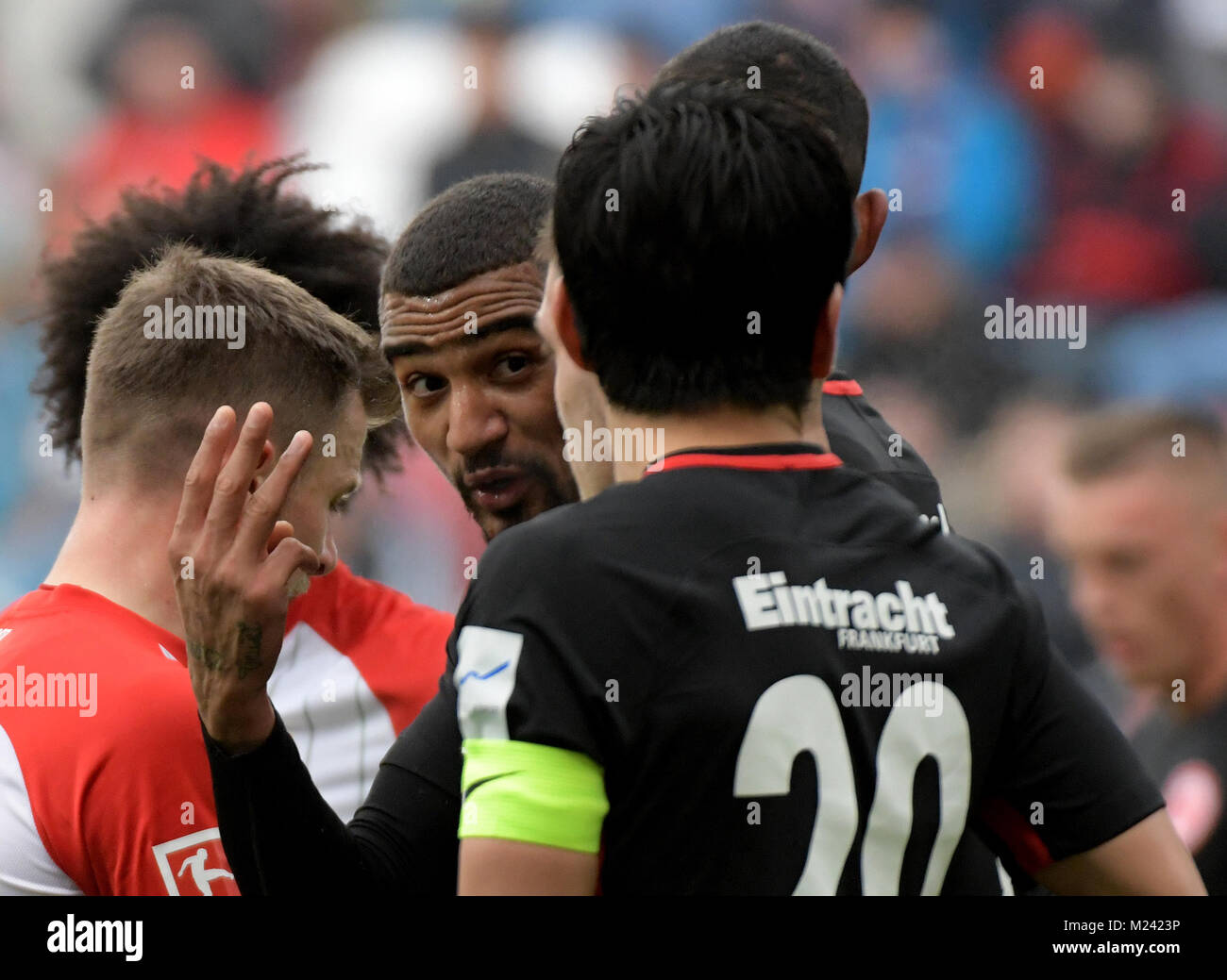 Munich's goalkeeper Stefan Ortega Moreno (R) catches the penalty shot by  Andreas Geipl of Regensburg (2-R) during the 2. Bundesliga relegation match  between Jahn Regensburg and TSV 1860 Munich at the Continental