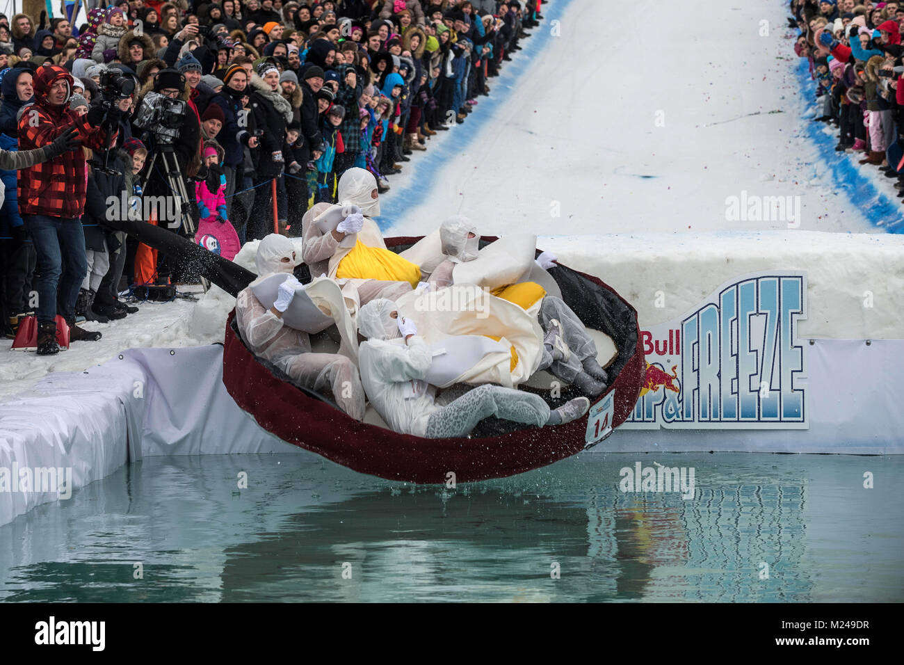 Vilnius, Lithuania Feb. 5, 2018 (Xinhua)-- Competitors slide from a snow  slope and jump into the freezing pool at the Red Bull Jump & Freeze  Festival 2018 in Vilnius, Lithuania capital of