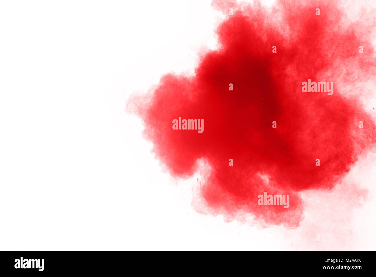 abstract red dust splattered on  white background. Red powder explosion on white background. Freeze motion of red particles splash. Stock Photo
