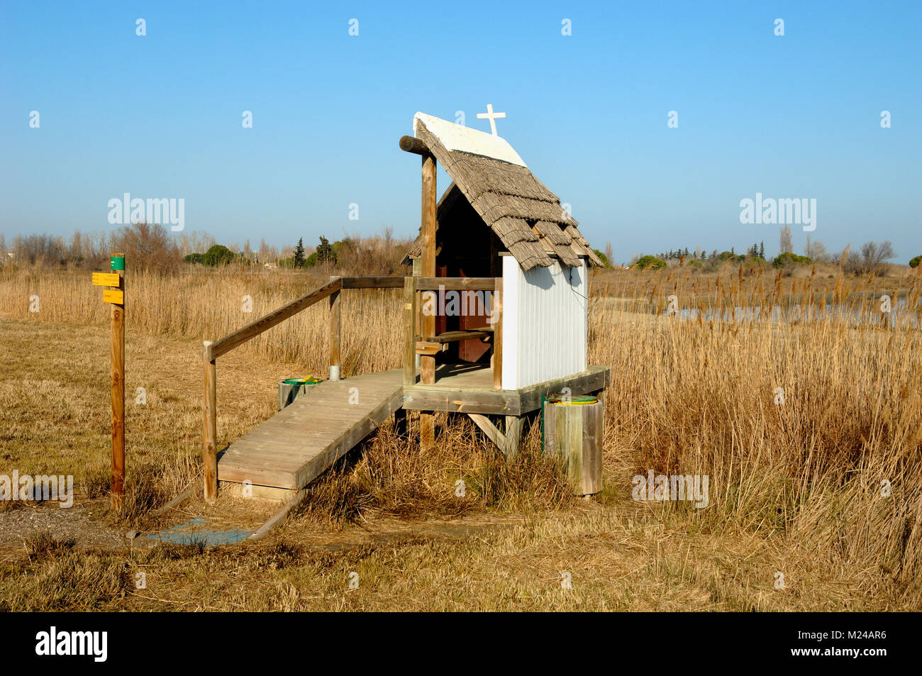 Wildlife Hide in the Shape of a Traditional Camargue Thatched House Overlooking Reedbeds in the Camargue Provence France Stock Photo