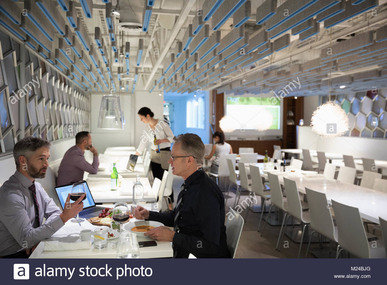 Businessmen drinking wine, enjoying working lunch at restaurant Stock Photo Alamy