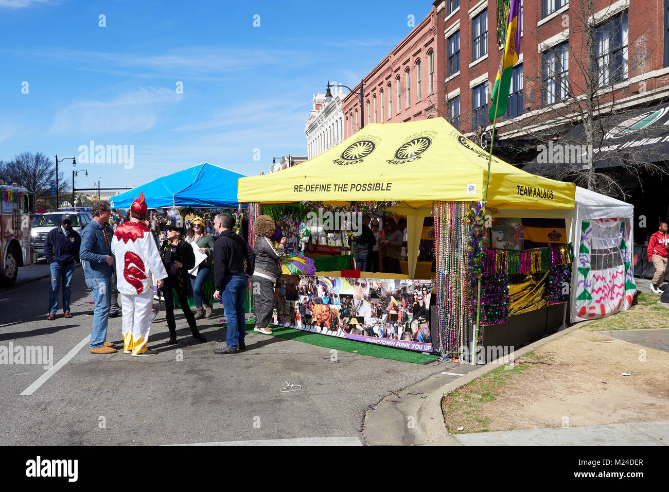 Sponsor tent at local downtown Mardi Gras street celebration with colorful strings of beads on display in Montgomery Alabama, United States. Stock Photo