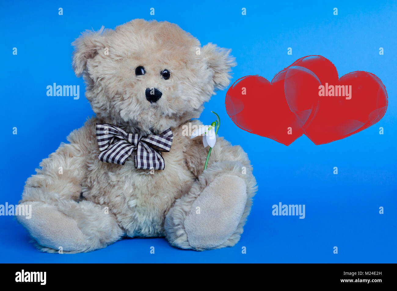 Cute teddy bear and red hearts for Valentine's Day Stock Photo - Alamy
