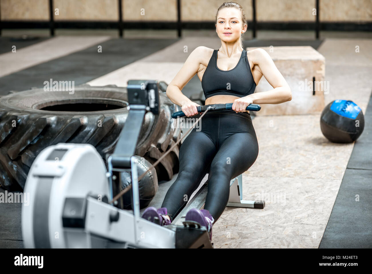 Woman training on the rowing machine Stock Photo