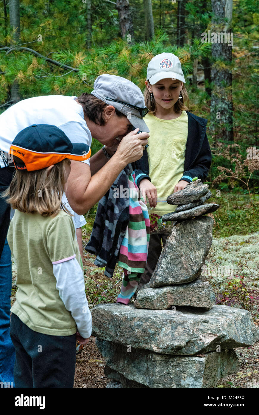 A grandmother and her grandchildren have discovered a green caterpillar