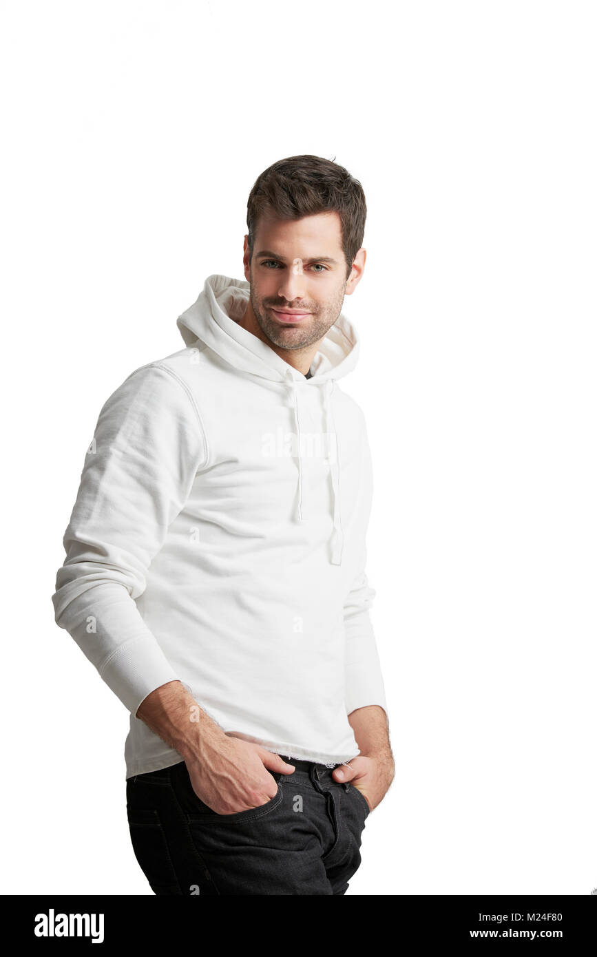 Portrait of young man wearing hoodie and looking at camera while standing  at isolated white background with copy space Stock Photo - Alamy
