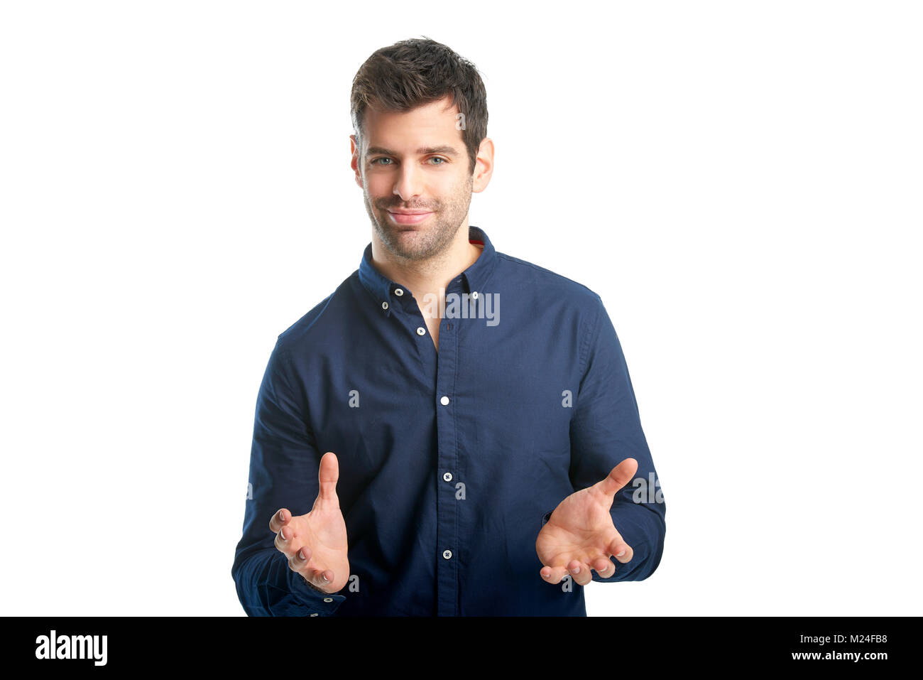 Portrait of a smiling young businessman standing with his arms raised ...