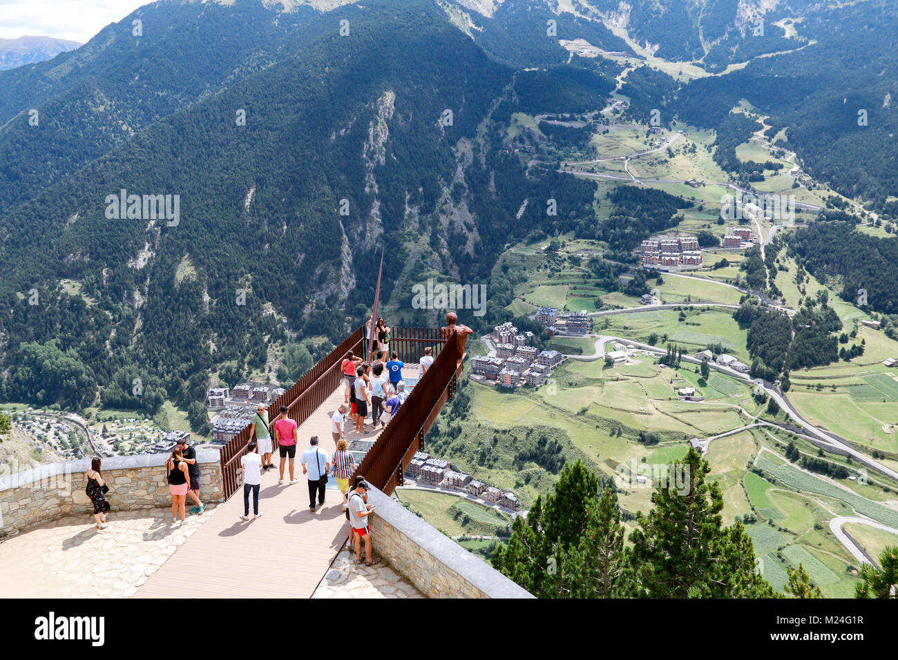 A group of tourists admiring the view of the Valira d'Orient in the Pyrenees Mountains from the Mirador Roc del Quer viewpoint, Canillo, Andorra Stock Photo