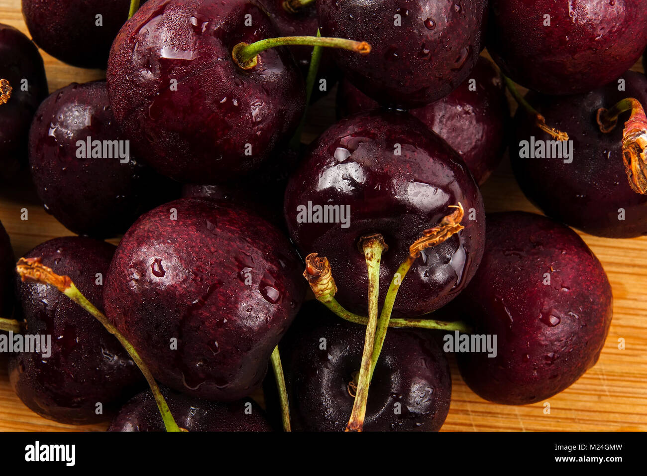 Sweet red cherries on a wooden background. Stock Photo