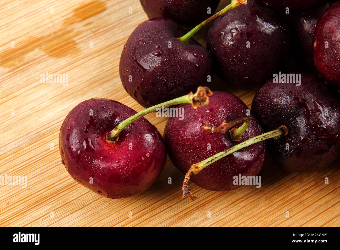 Sweet red cherries on a wooden background. Stock Photo