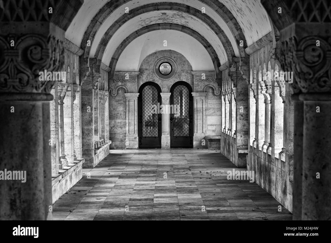A grand and long corridor in Budavári Palota (Buda Castle), Budapest, Hungary photographed in black and white. Stock Photo