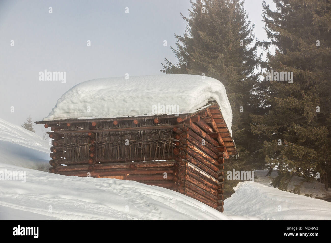 A lot of snow on the roof in the mountains Stock Photo