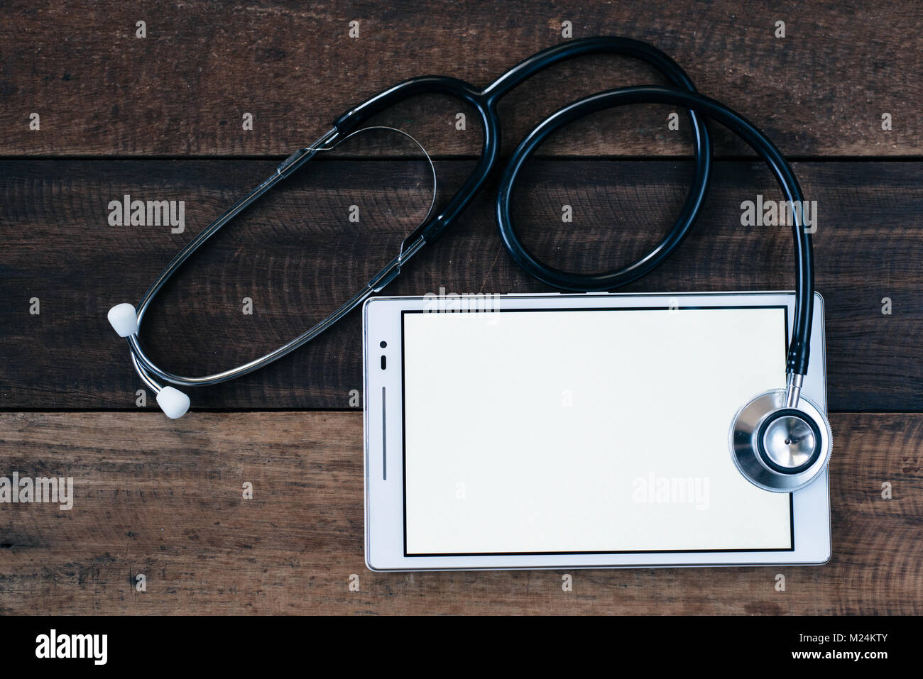 Stethoscope and digital tablet on wooden table background. medical ...
