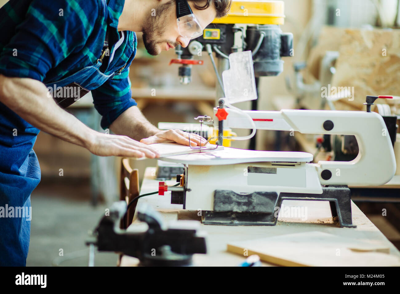 Carpenter engaged in processing wood at the sawmill Stock Photo Alamy