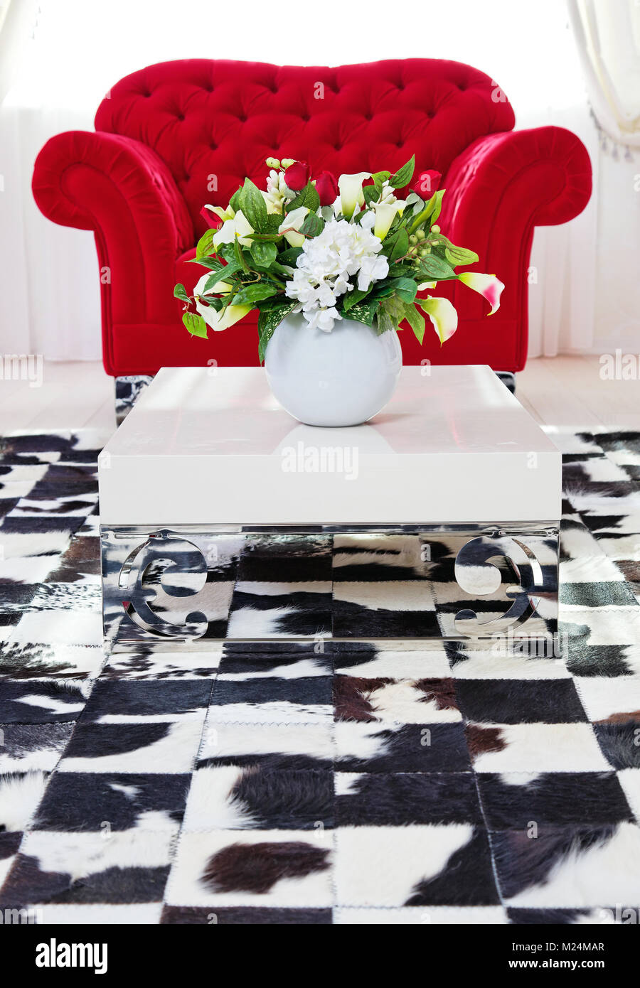 Red classical armchair in living room interior near white coffee table