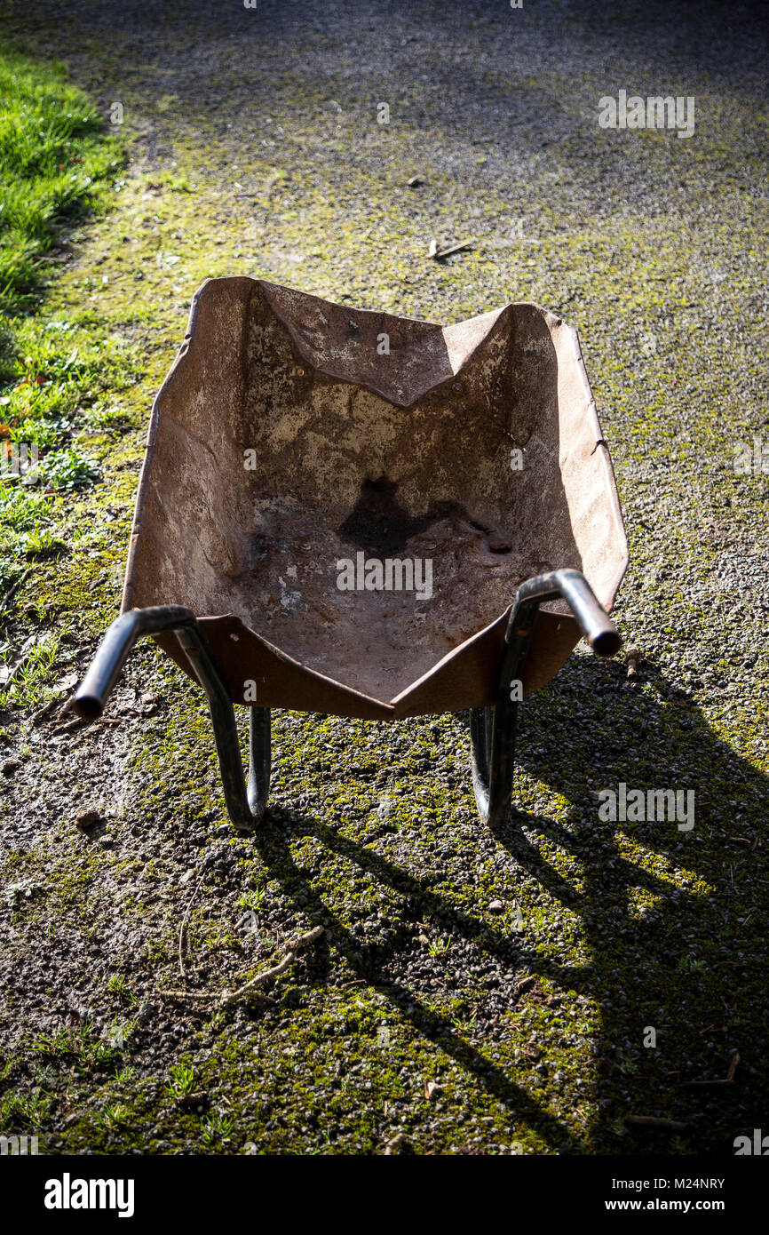 handcart, pushcart, trolley, barrow,A small cart with a single wheel at the  front and two supporting legs and two handles at the rear, used typically  Stock Photo - Alamy