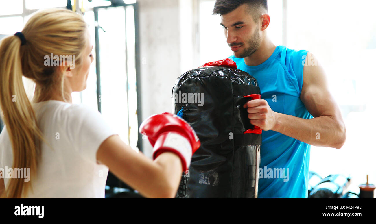 Picture of woman wearing boxing gloves in gym Stock Photo