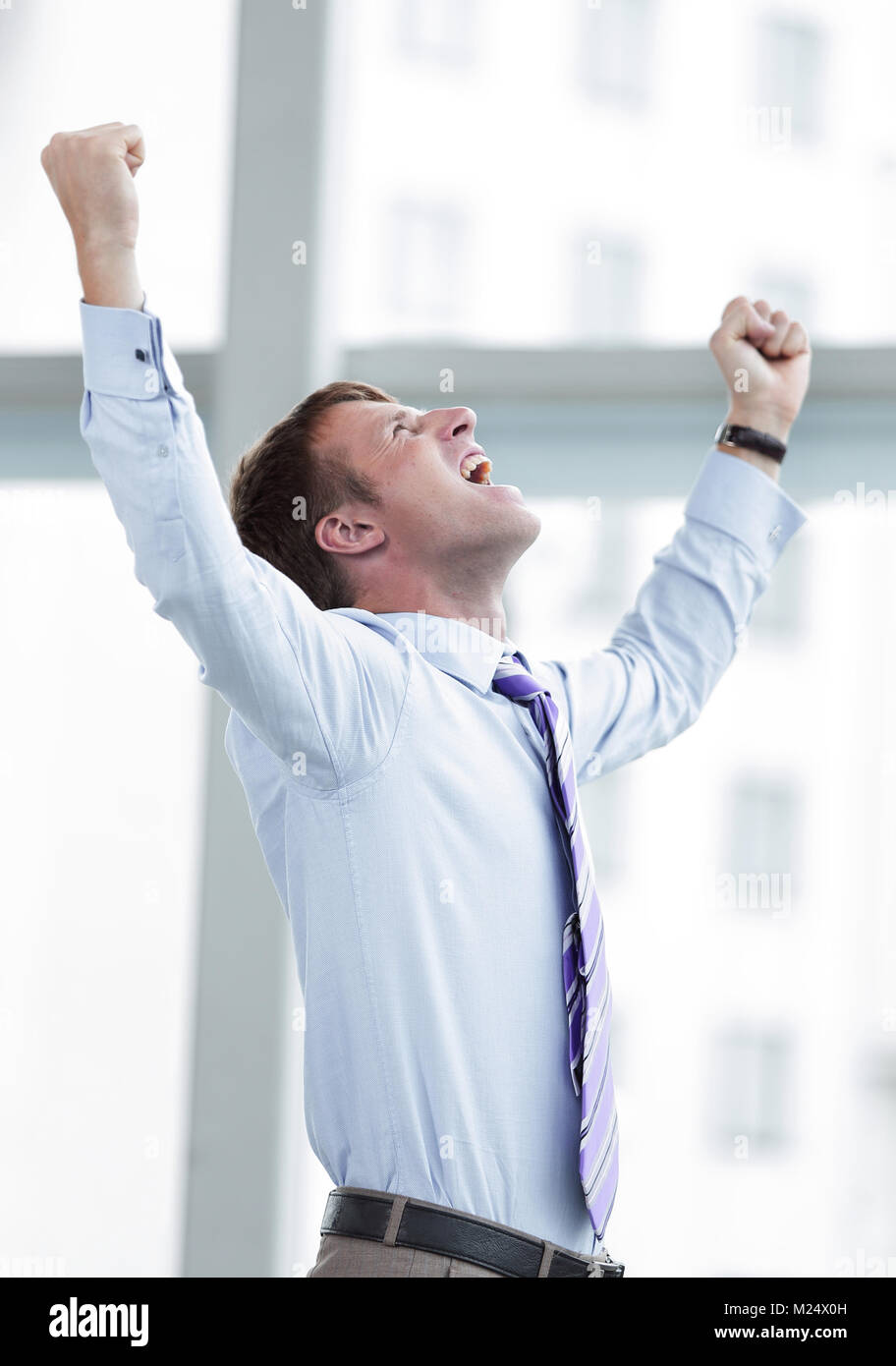 Businessman celebrating with his fists raised in the air Stock Photo ...