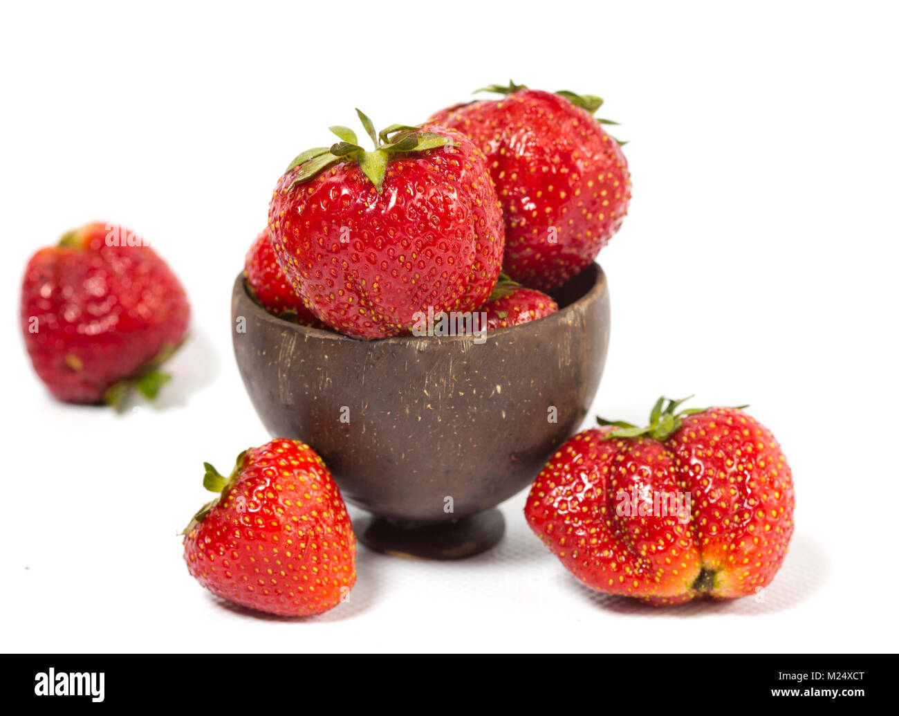 strawberry, ripe berries drop out of a wooden bowl Stock Photo