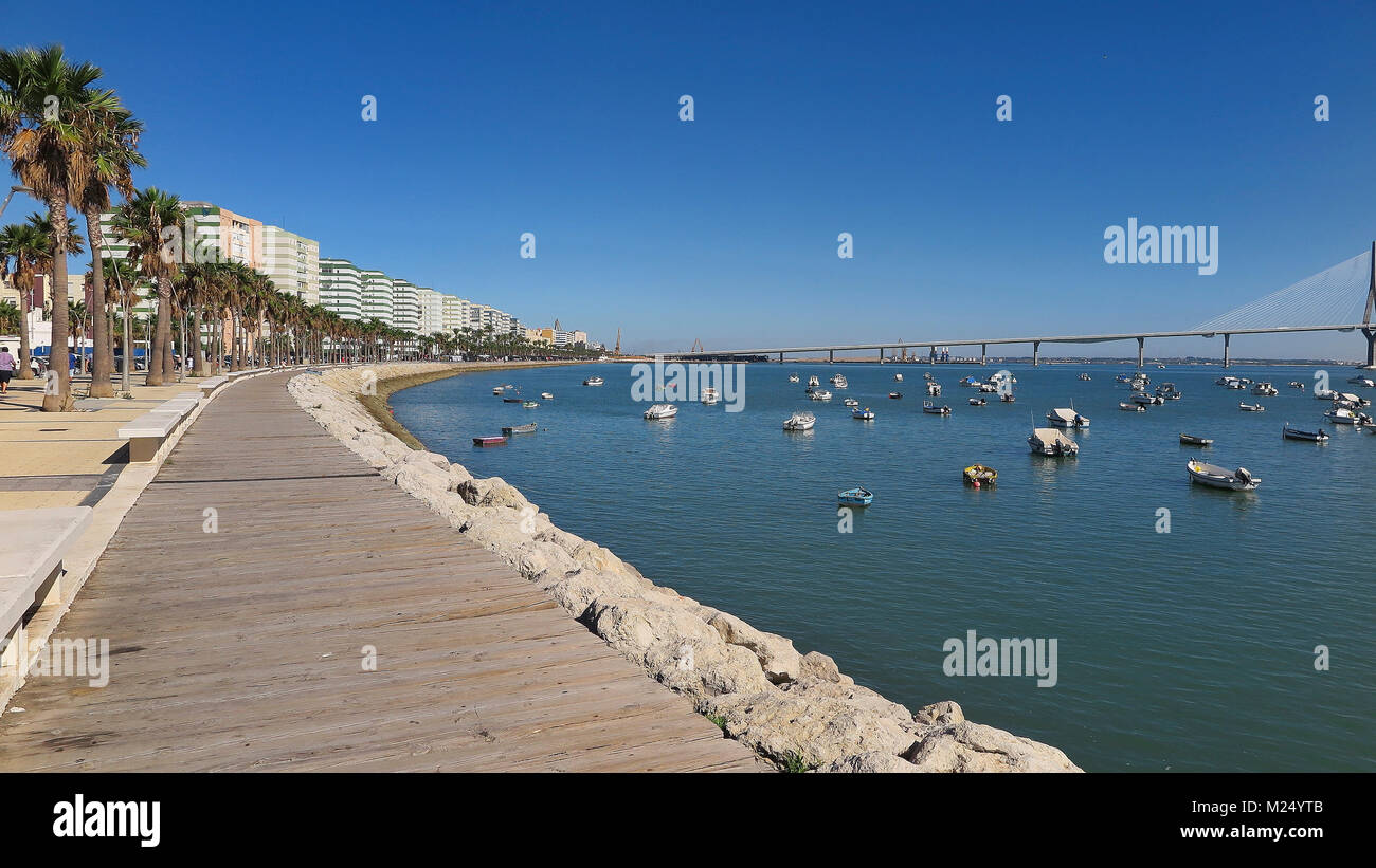 horizontal view of seafront promenade and small wooden boats in the port of cadiz, spain Stock Photo