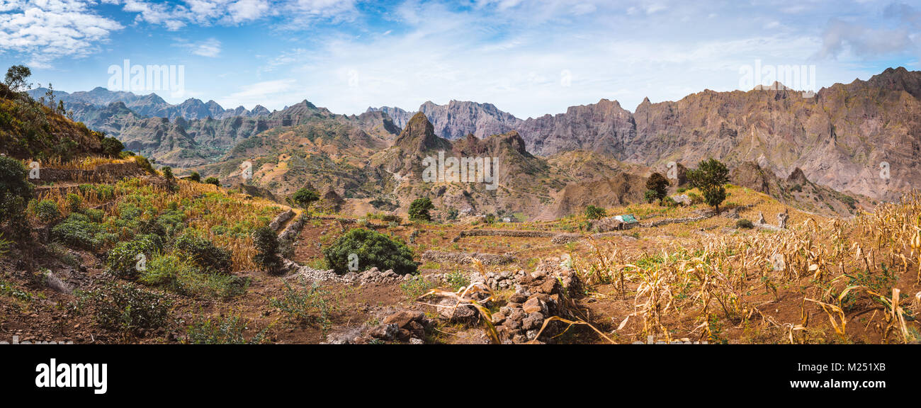 Gorgeous panorama view of the fields of intensive terrace cultivation surrounded by the huge barren mountain peaks, walls and cliffs. Santo Antao Island, Cape Verde Stock Photo