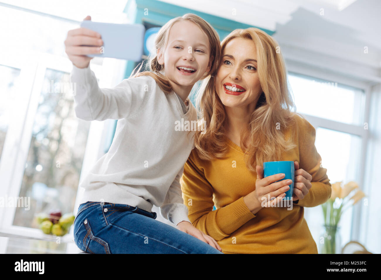Content mother and daughter taking selfies Stock Photo - Alamy