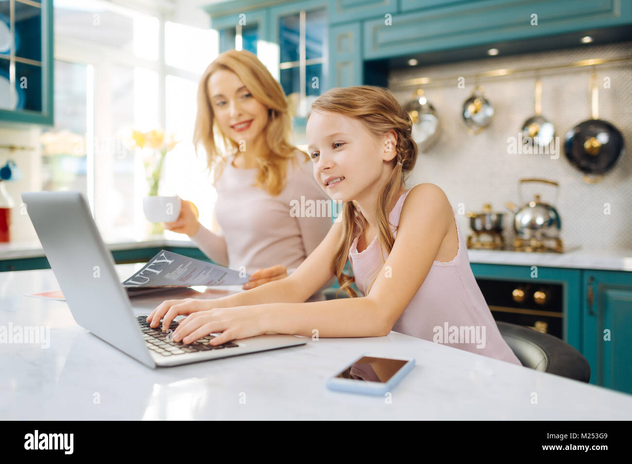 Cheerful girl working on the laptop Stock Photo - Alamy