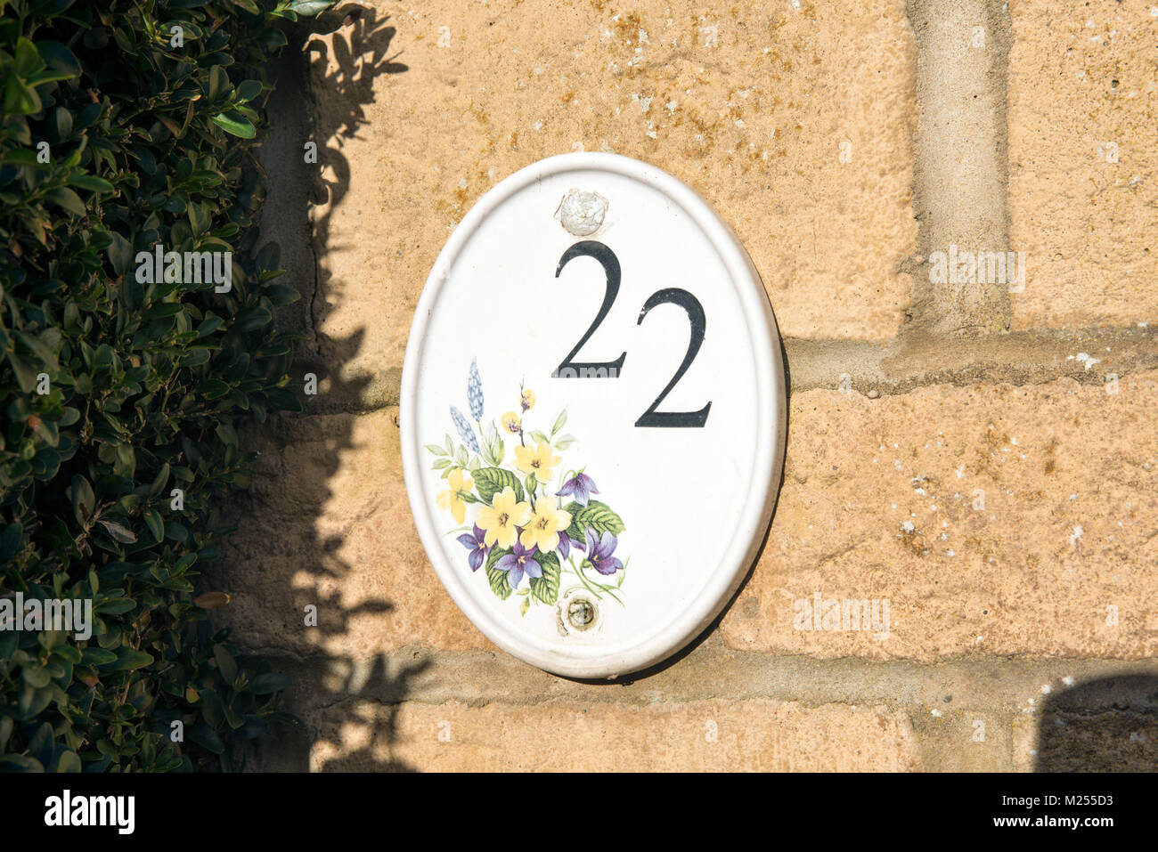 The number twenty two printed on a ceramic tile plaque on a home to show the properties address Stock Photo