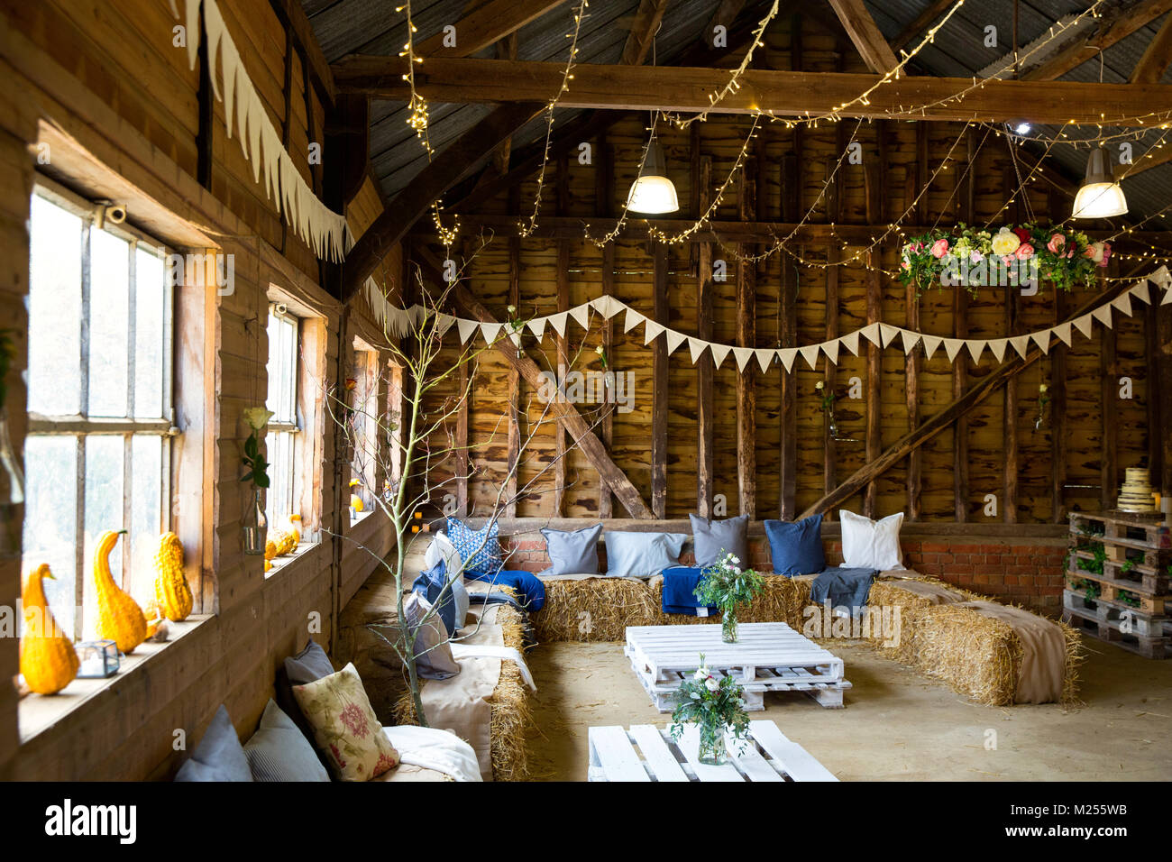Barn decorated for special occasion with bunting and straw bale seating Stock Photo