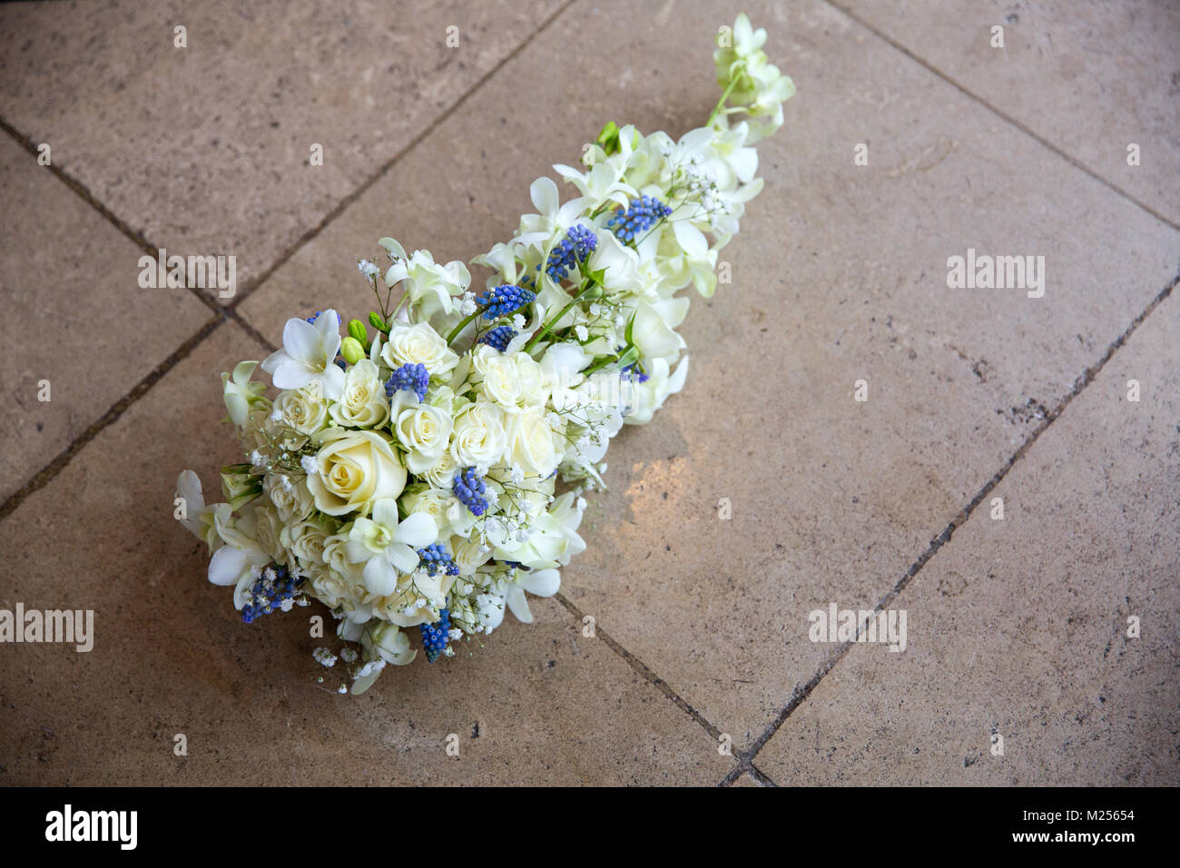 White bridal wedding bouquet on floor tiles, elevated view Stock Photo