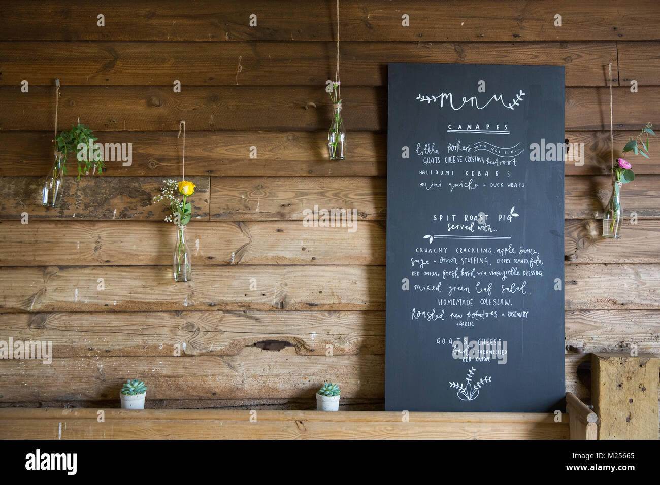 Blackboard menu sign in barn at wedding reception Stock Photo