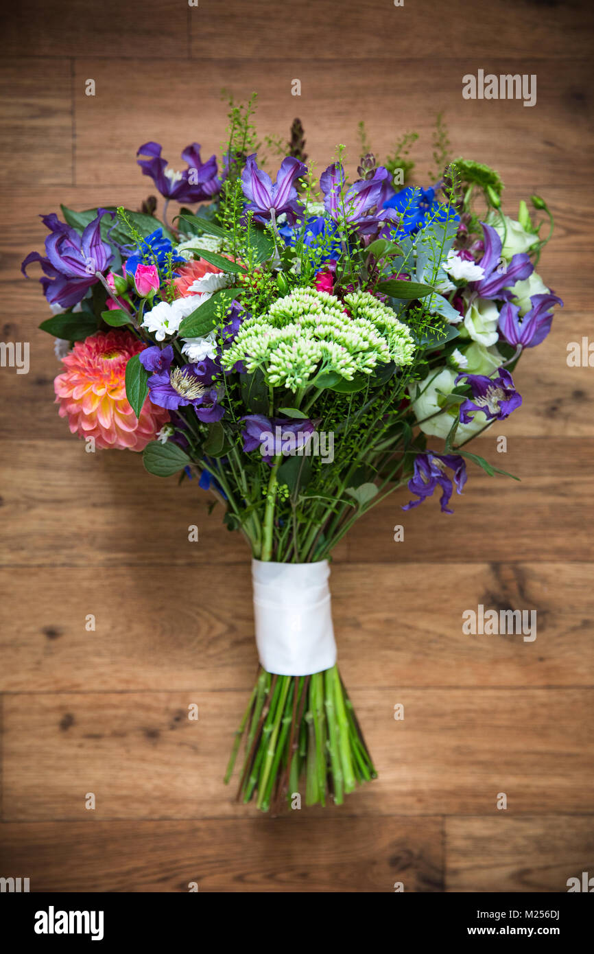 Colourful wedding bouquet tied with white ribbon, overhead view Stock Photo