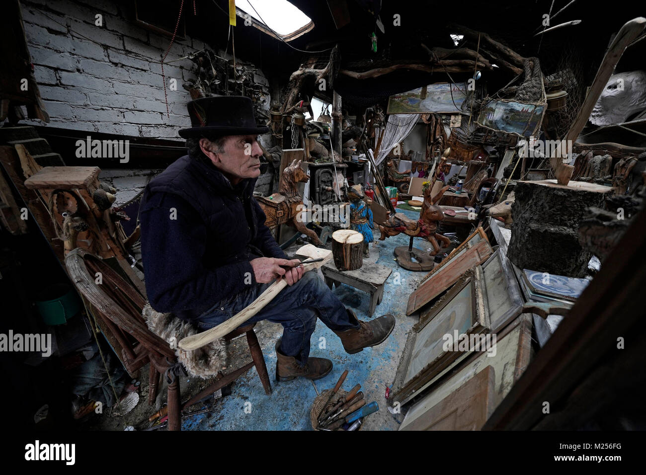 Tom Newstead, 71, a sculptor and carpenter for over 50 years in his shack on near the beach in Seaton Sluice on the Northumberland coast. Tom has been collecting drift wood from the beaches along the Northumberland coastline for decades and sculping and making it into many different and stange subjects for charity or to sell on , he calls his work Shanti Art. Tom is working on a life size scultpture of a moner in Blyth at the moment from an old tree stump and has been commissoned to transform other trees .......PA Photo Owen Humphreys Stock Photo