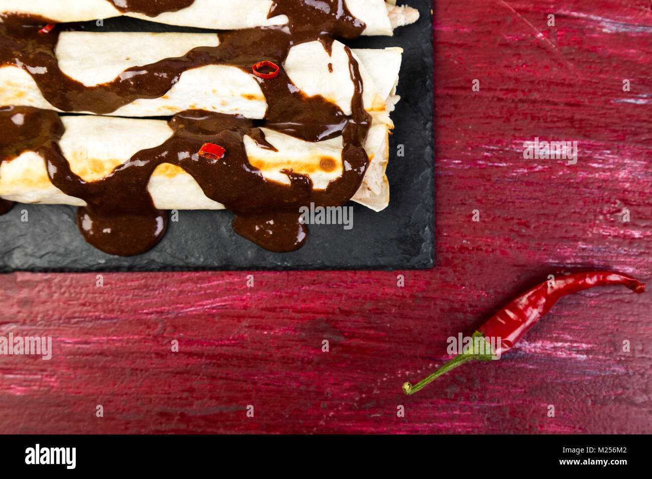 Mexican chicken enchiladas with chili chocolate salsa mole poblano