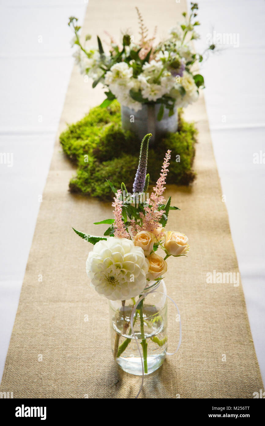 Floral arrangements on wedding reception table Stock Photo