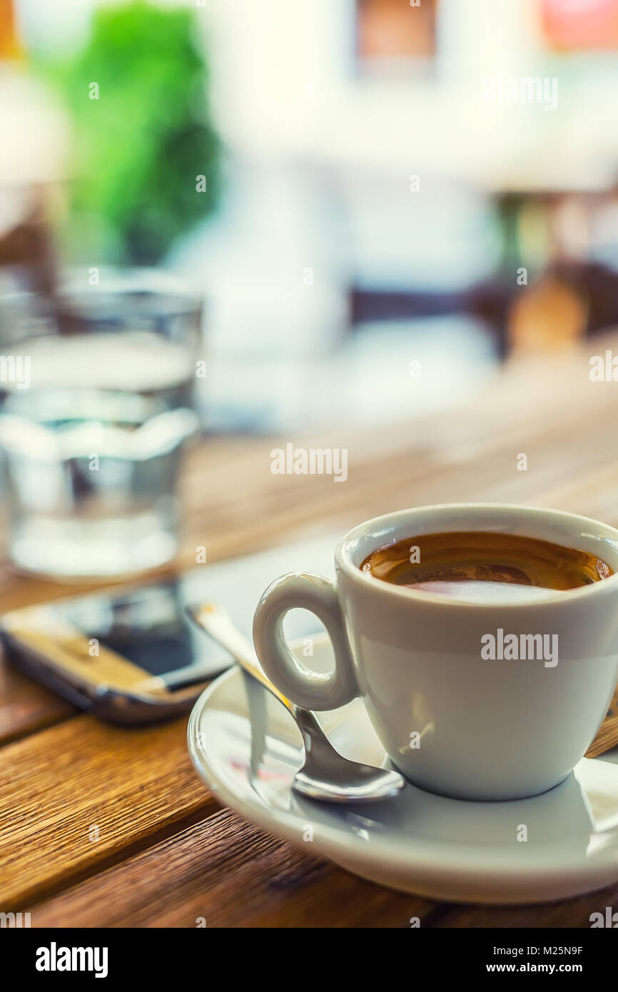 Coffee. Cup of coffee mobile phone on table on restaurant coffee house
