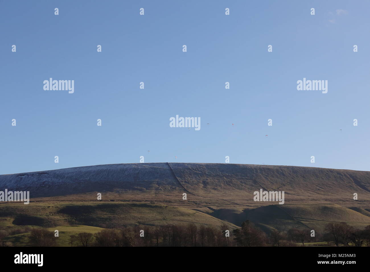 Imposing Pendle Hill, Lancashire, with paragliders in the distance. Stock Photo