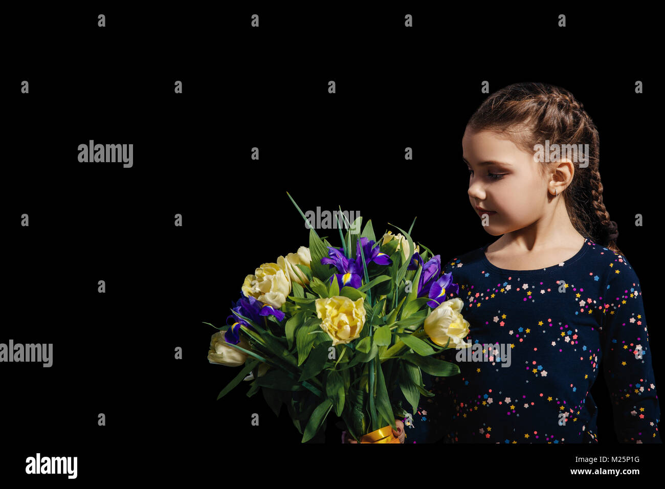 Little girl with bouquet of flowers in her hand. The concept of happiness, people, child, childhood. Studio photo on a black background. mothers Day.  Stock Photo