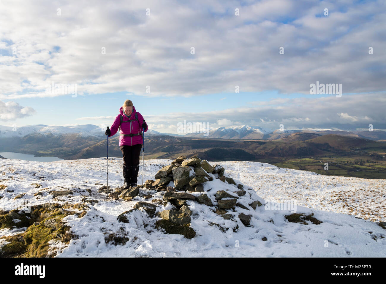 Hill Walker Approaching the Summit of Arthur's Pike in Winter, Lake District, Cumbria, UK. Stock Photo