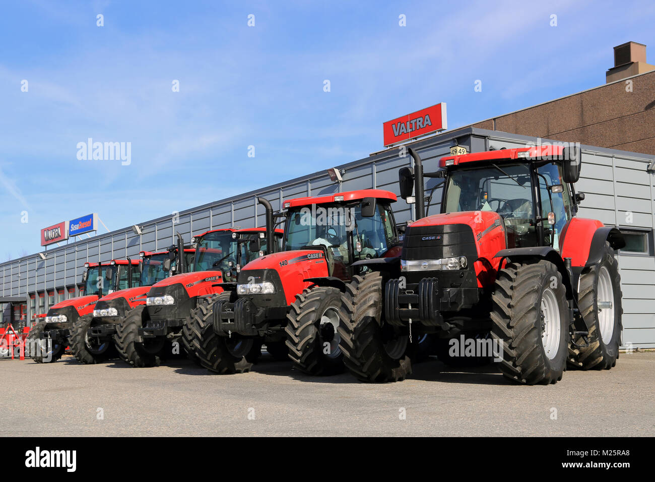 TURKU, FINLAND - APRIL 5, 2014: Five Case IH agricultural tractors displayed in a row. Case IH wins two gold medals at AGROTECH - the 20th Internation Stock Photo